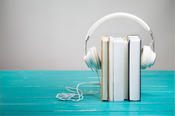Books wearing headphones for Audiobook Month