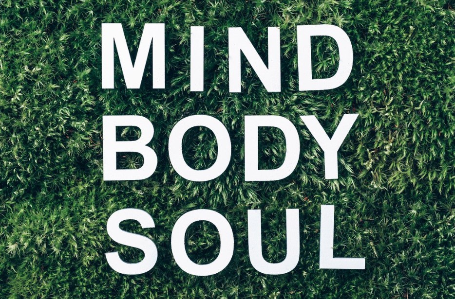 MIND BODY SOUL in white on dark green grass. Holistic Therapy Day