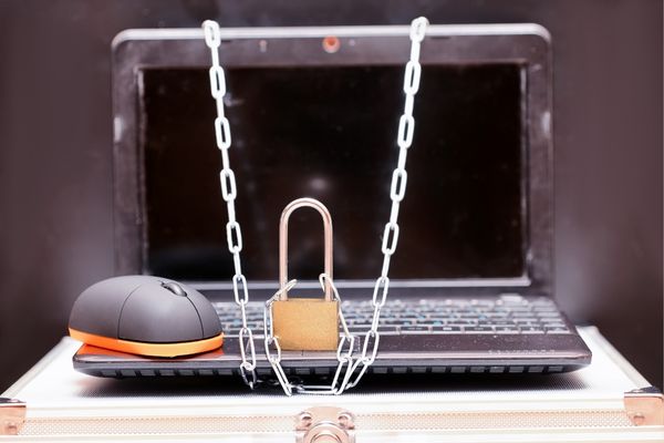 A laptop with a lock and chains on it for World Password Day