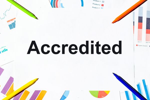 The word ACCREDITED on white background with a stationery border