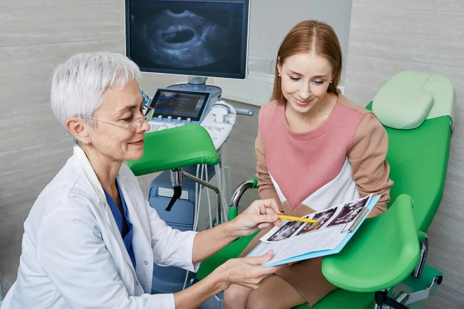 Young woman looks at scan results with doctor for Gynaecological cancer day