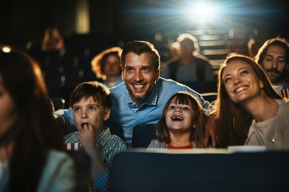 A family laughs at a movie on National Cinema Day