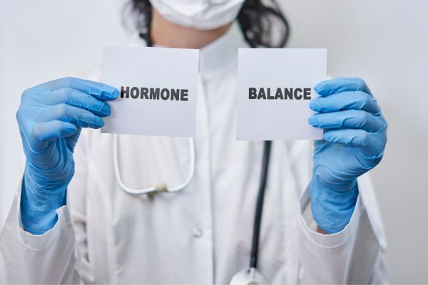 A health professional holds signs saying Hormone Balance for European Hormone Day