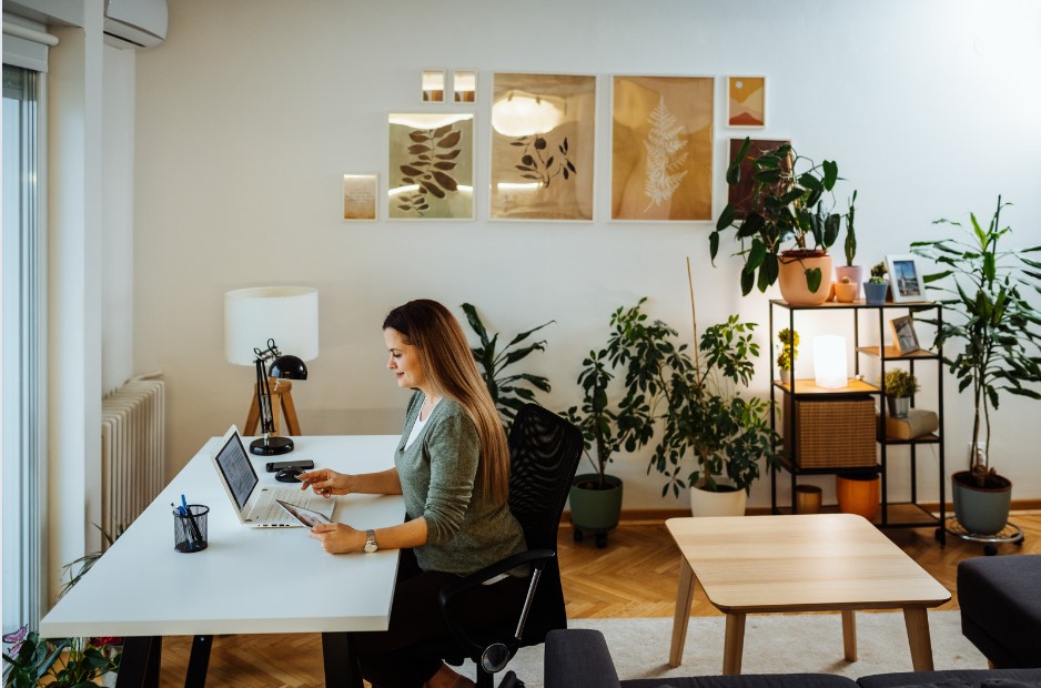 A woman works at a desk in her home for Flexible Working Day