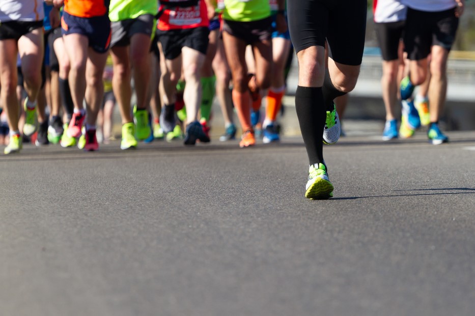 People running along a street for the Cardiff Half Marathon