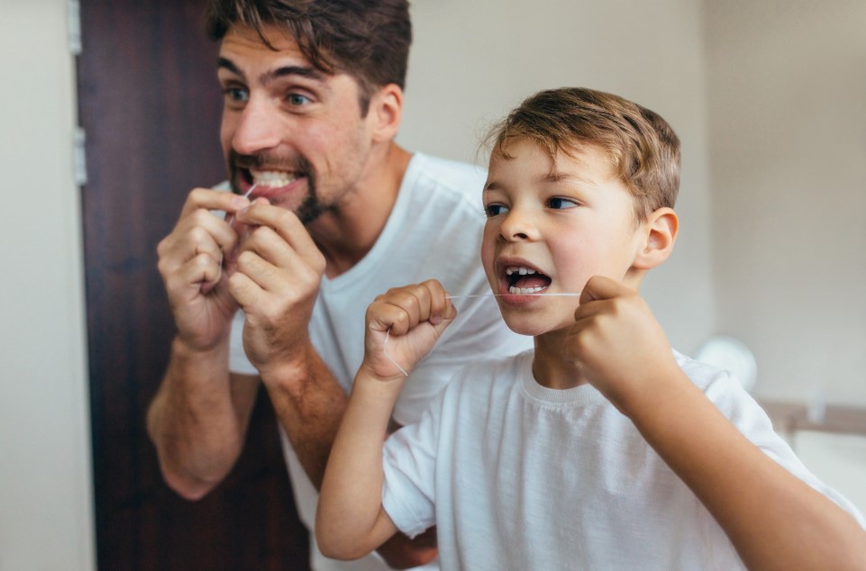 Father and son flossing for flossing day